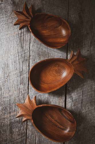 spoon three brown wooden bowls on gray wood cutlery